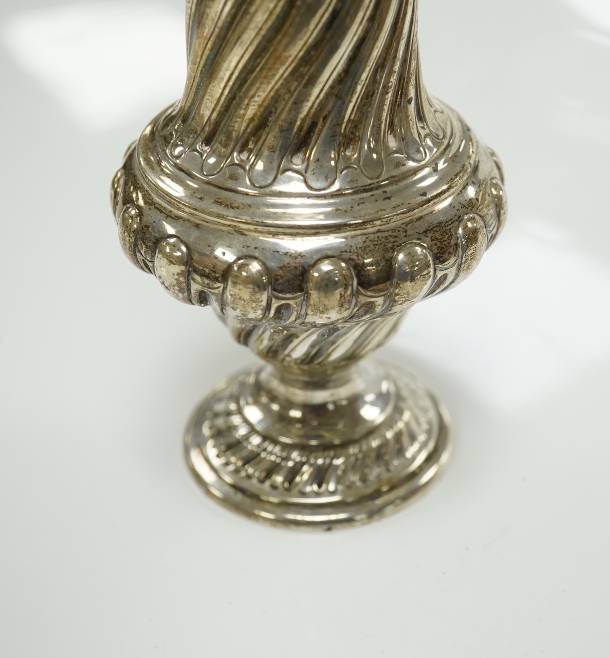 A Victorian repousse spiral fluted pedestal sugar caster, Thomas Bradbury & Sons, London, 1889, 18.3cm, 3.9oz. Condition - fair